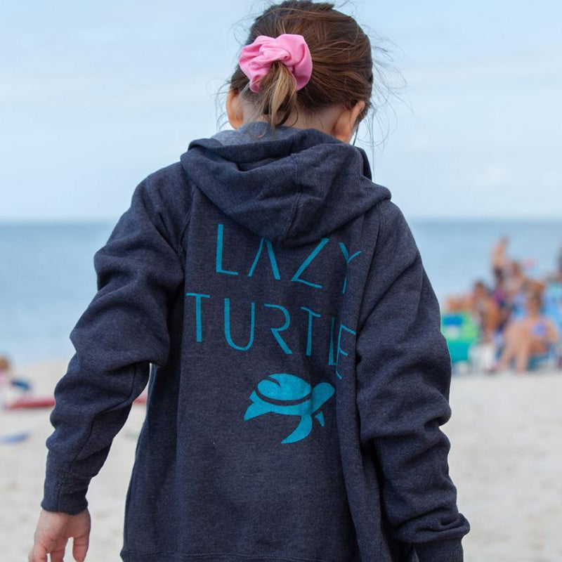 Back view of girl wearing AJ Hoodie on beach